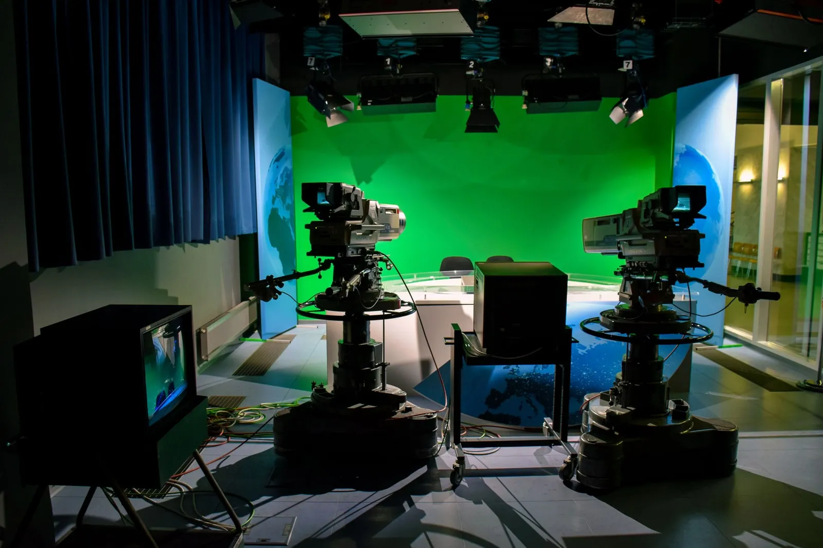 A film camera on a tripod in a production studio