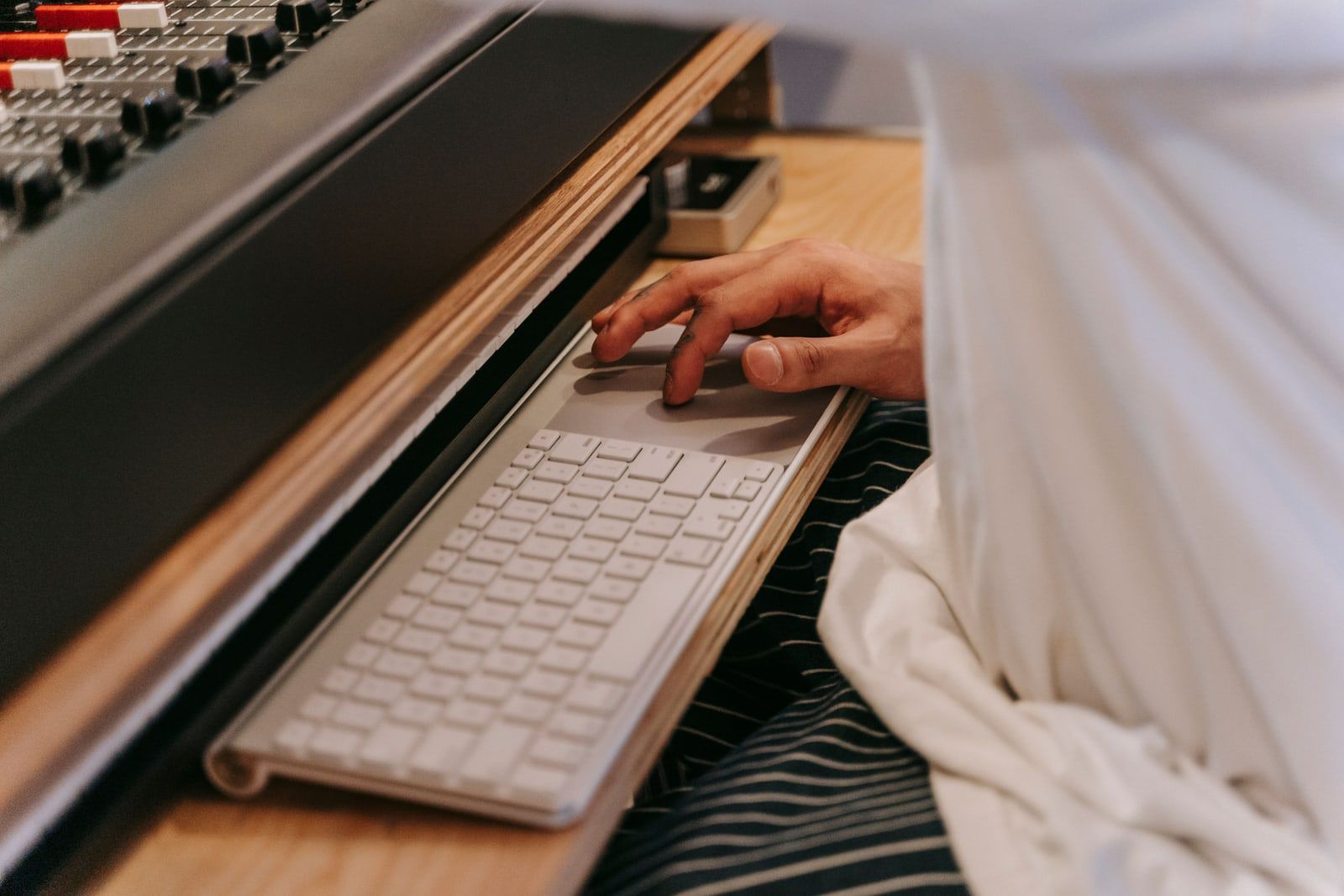 A computer and keyboard in a home recording studio