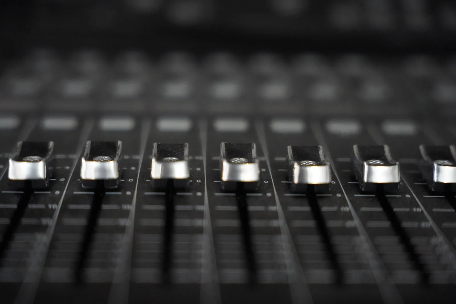 An audio mixing console with faders