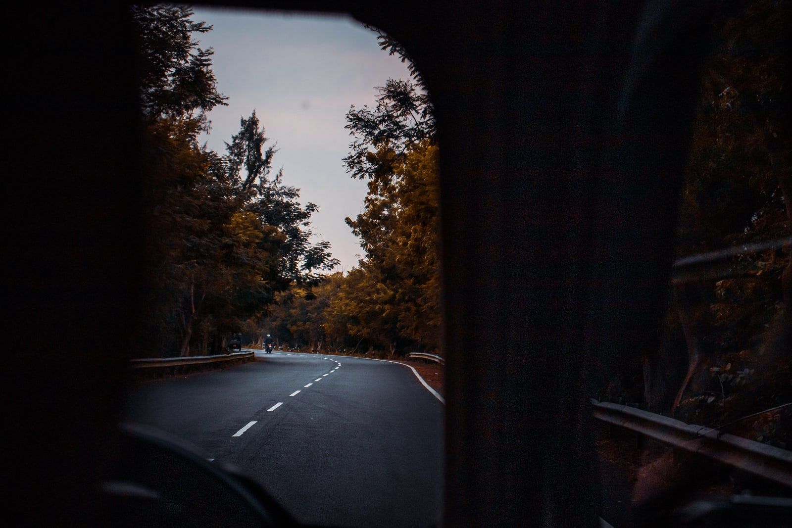 The view of a road through a car windscreen