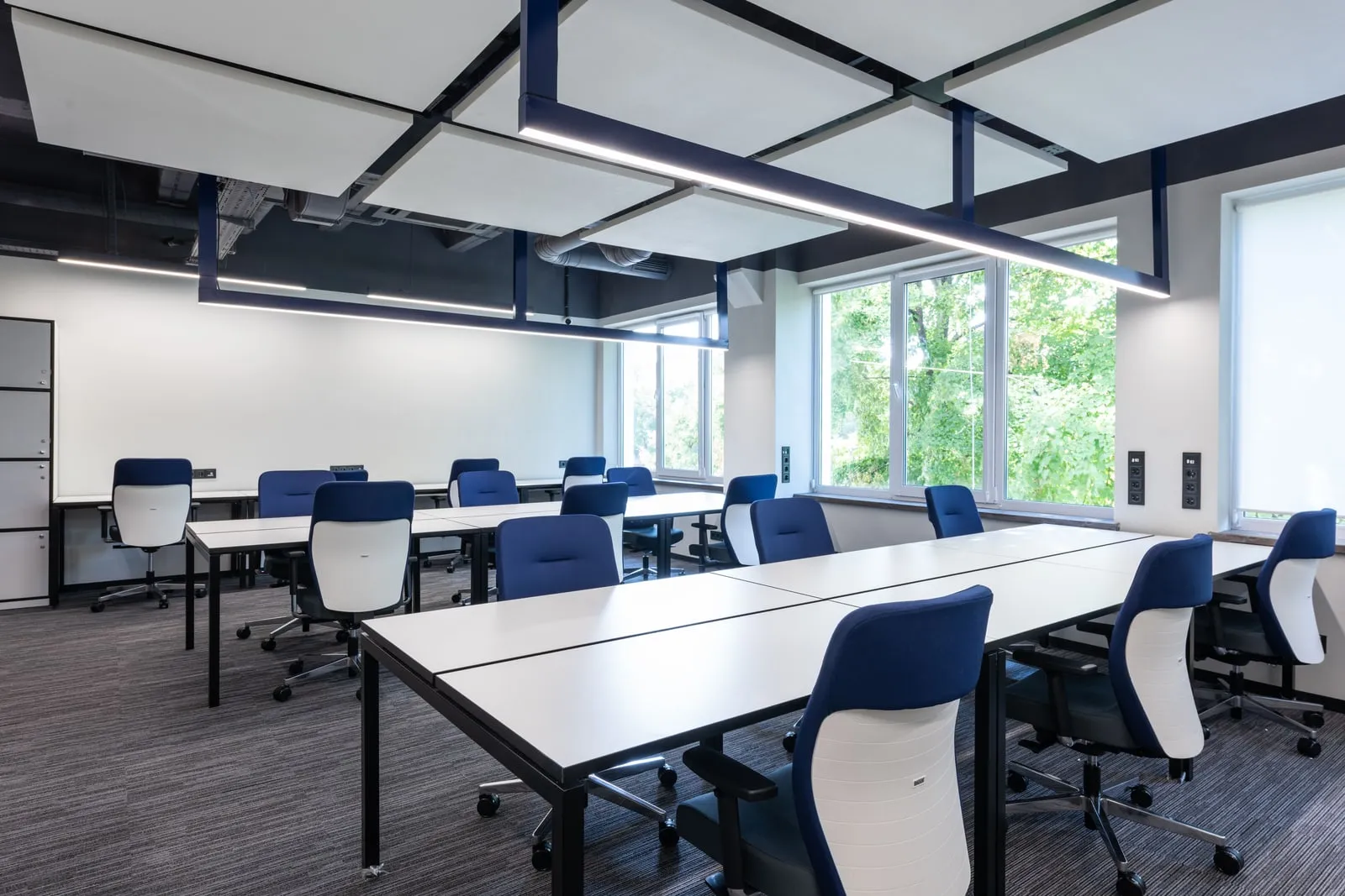 An empty open-plan office with rows of unoccupied desks
