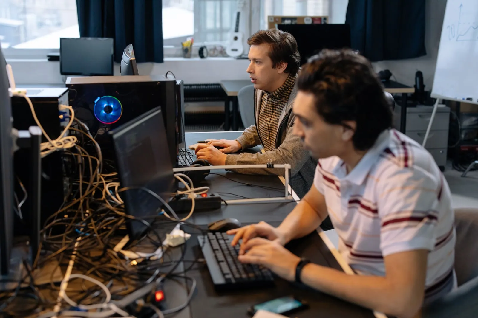 Software engineers working at desks in a shared office