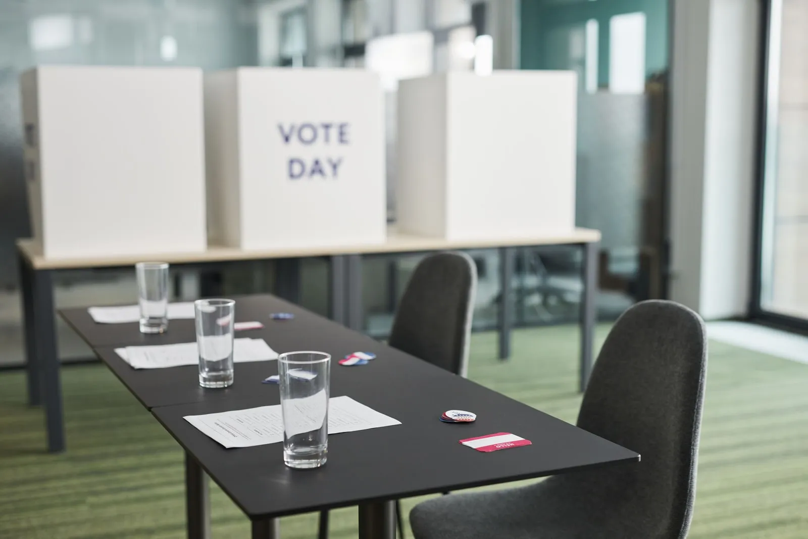 Empty voting booths lined up in a hall
