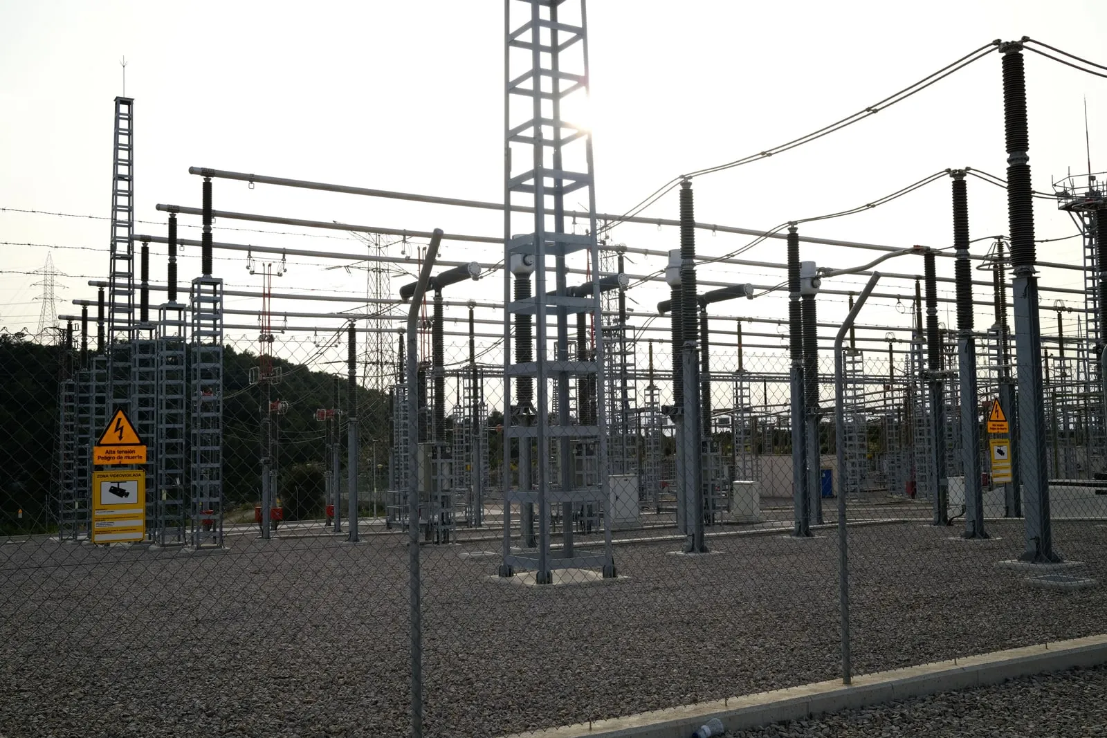 Electrical substation transformers behind a fence