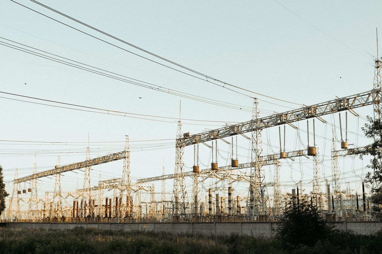 High-voltage transmission gantries and lines at a substation