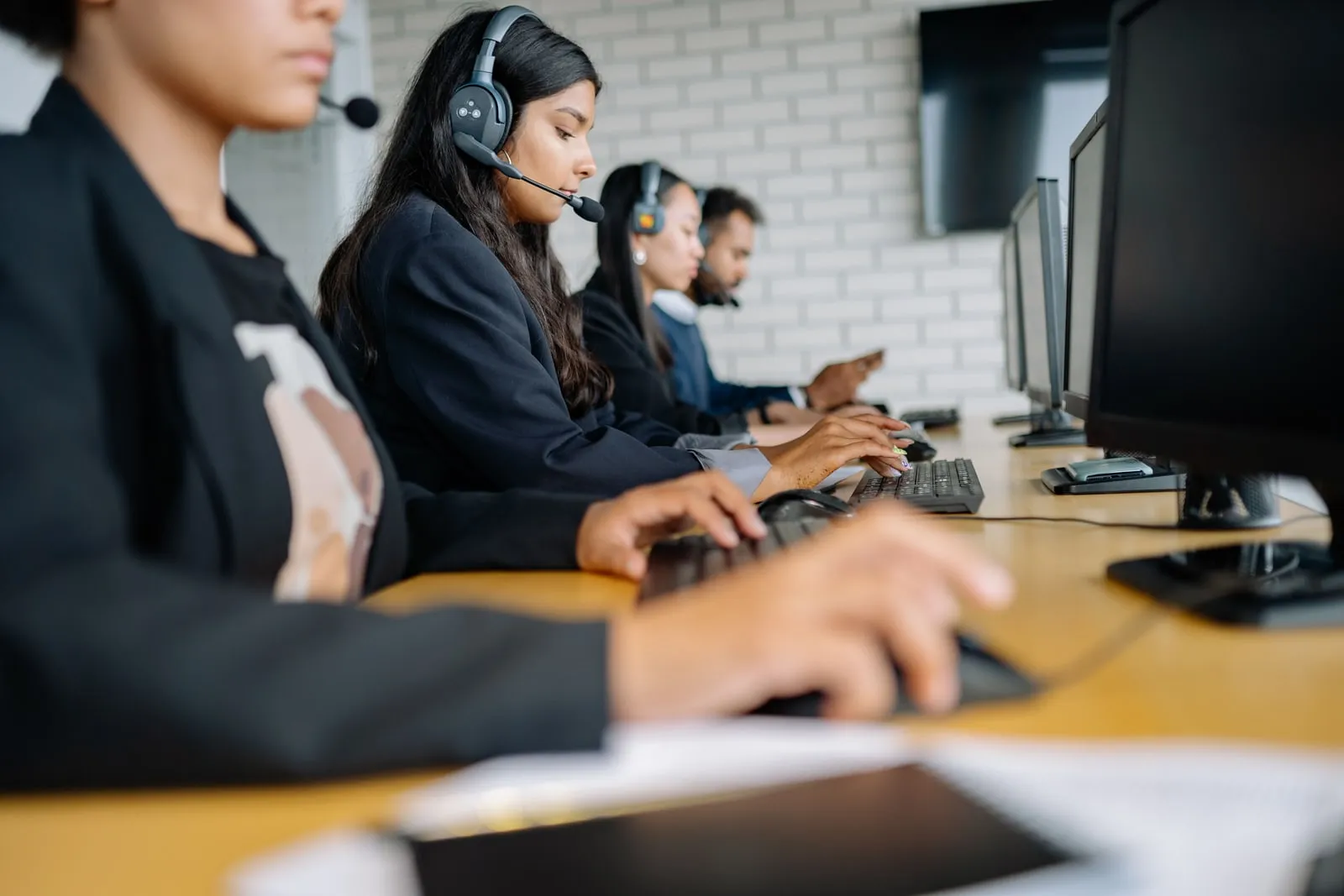 Call centre operators wearing headsets at their desks