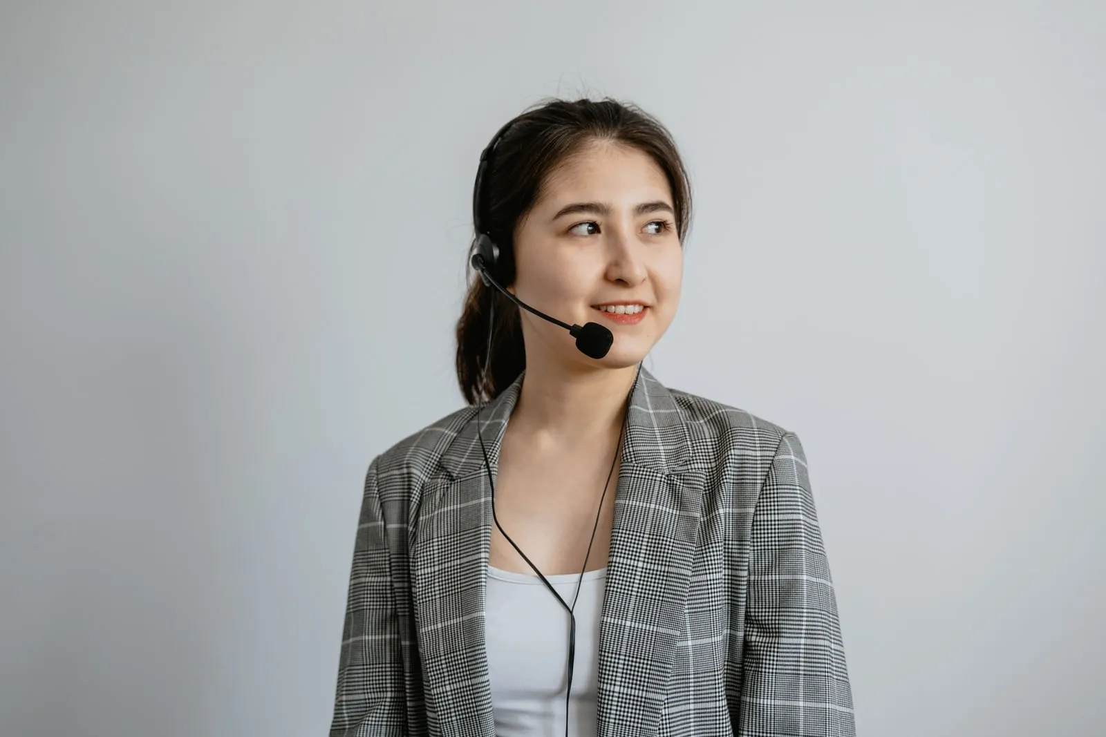A call centre operator wearing a headset at a workstation