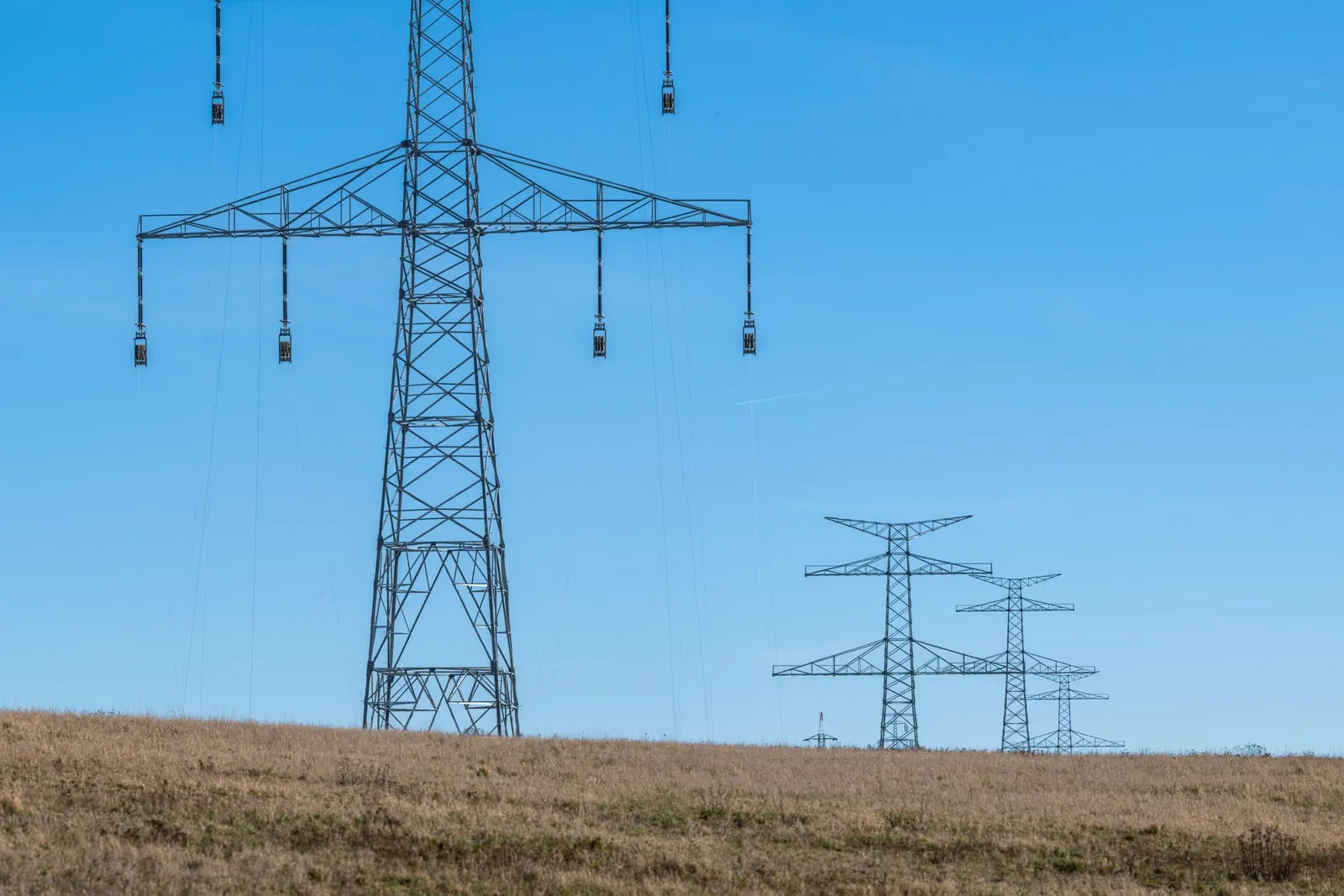 High voltage transmission pylons against the sky