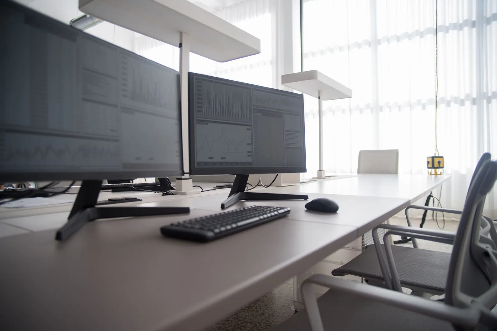 Desks and computer monitors in an open plan office