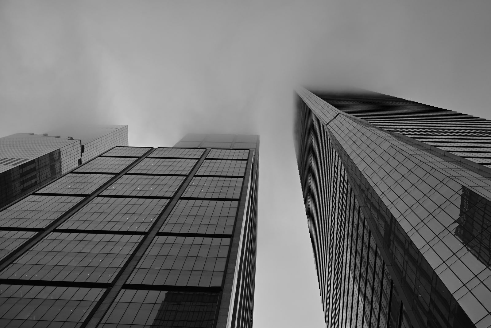 Two glass skyscrapers seen from below