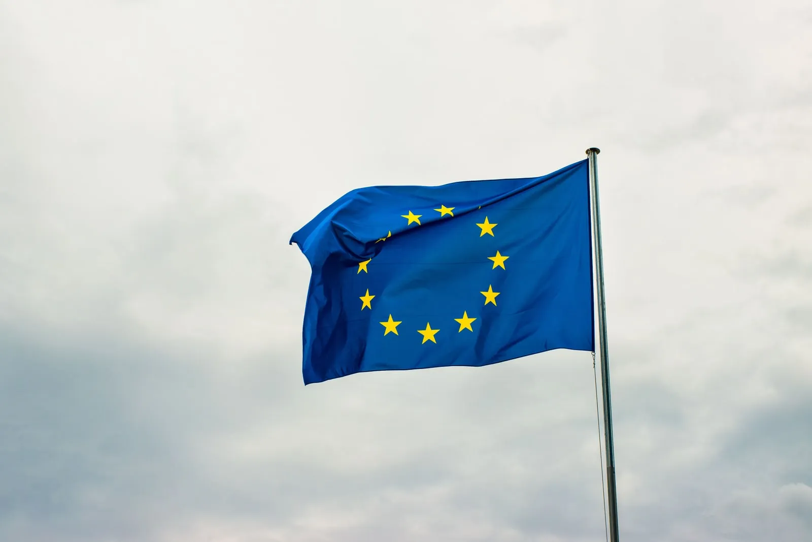 The European Union flag flying on a flagpole