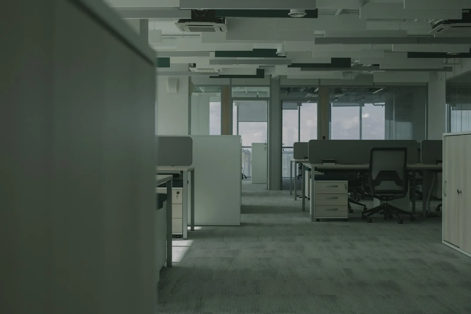 An empty open-plan office with glass partitions