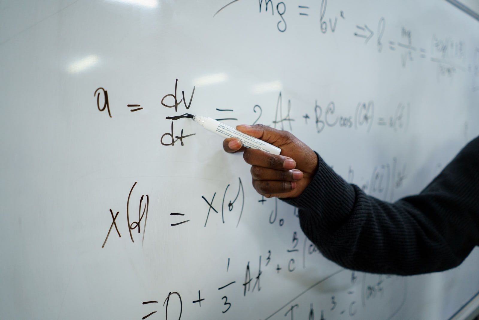 A whiteboard covered in handwritten equations