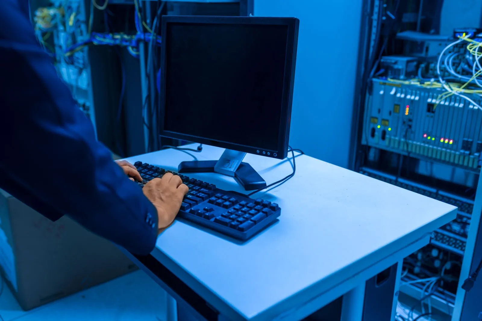 A technician working on rack mounted equipment