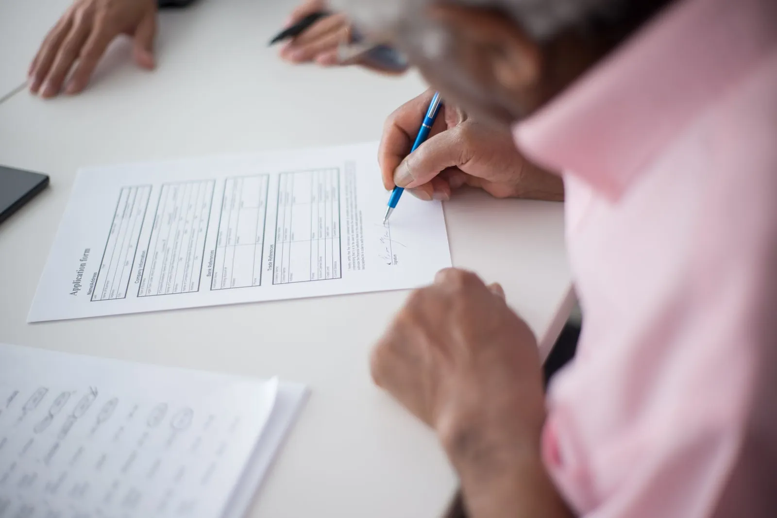Human resources paperwork spread across an office desk