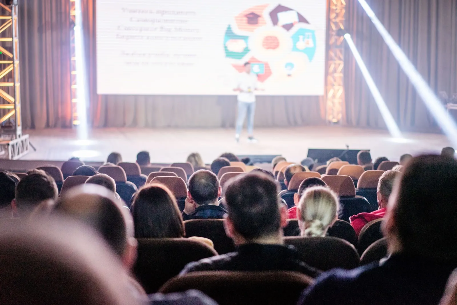 An audience listening to a speech in a conference hall
