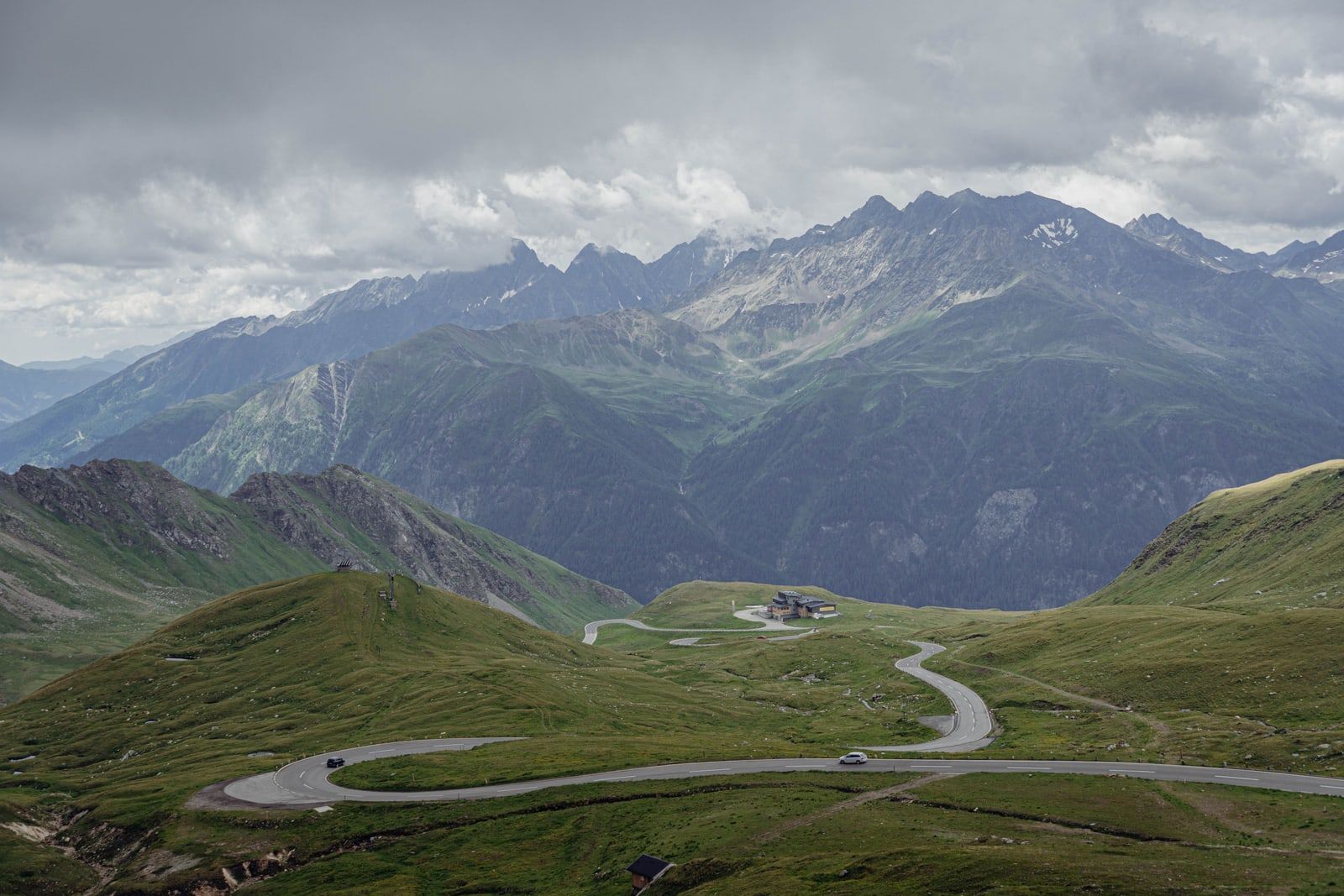 A winding road through green hills under a clear sky