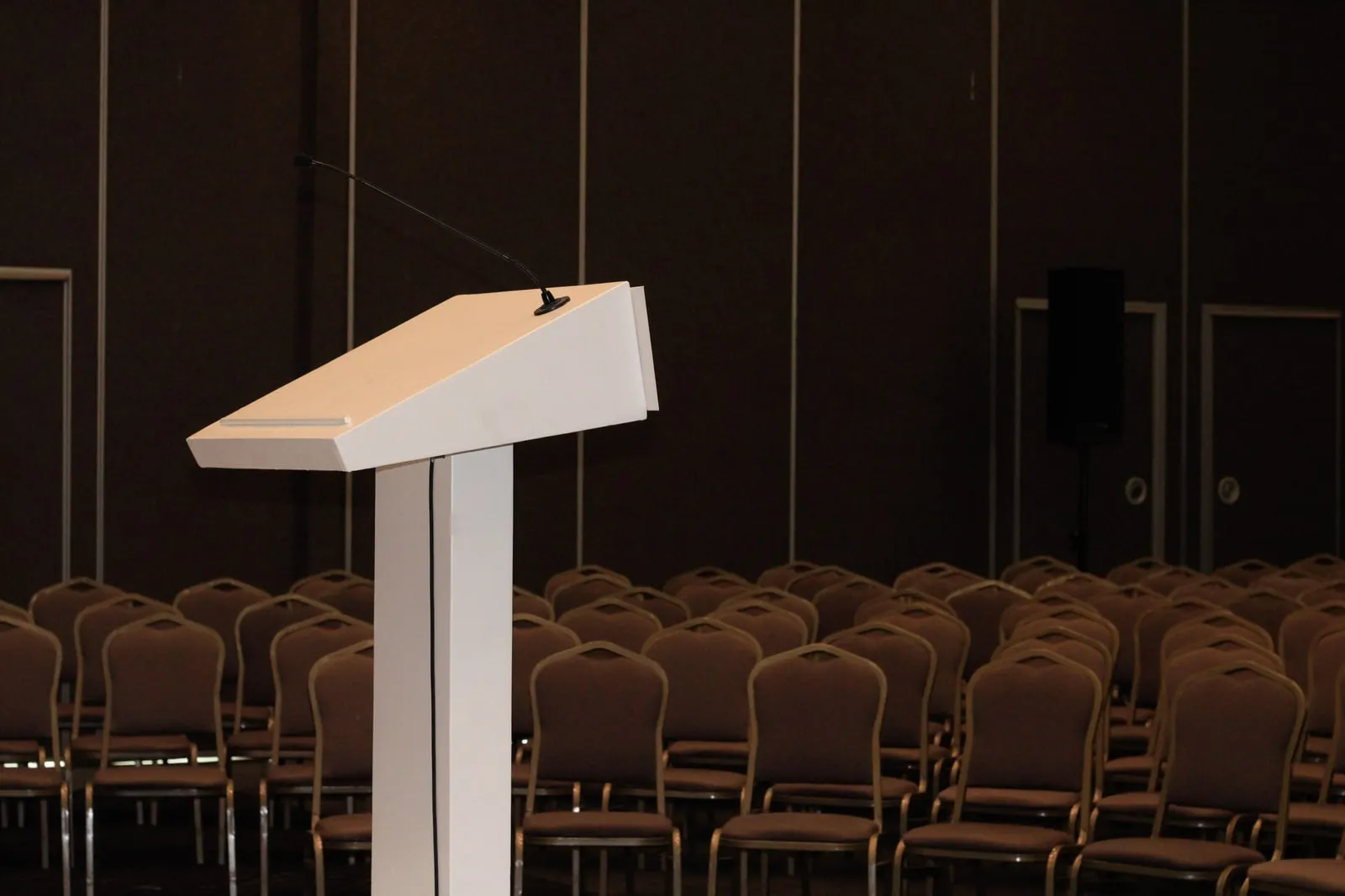 A microphone on a podium in a conference hall