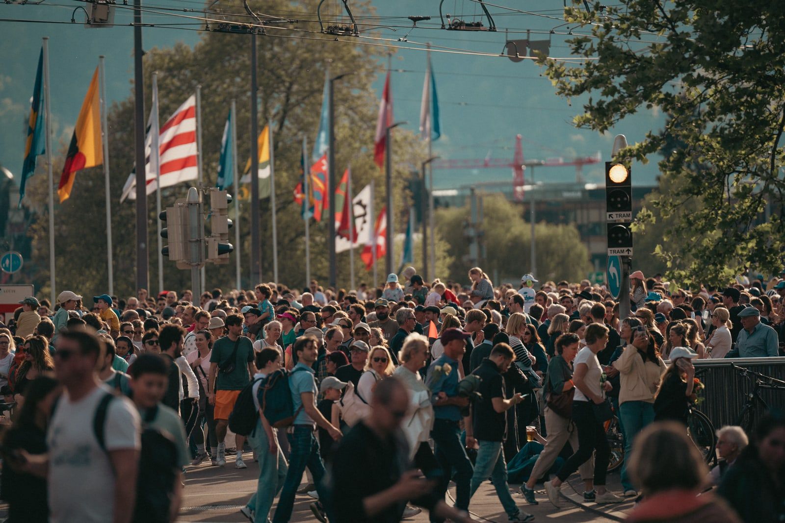A crowd of people walking along a busy city street