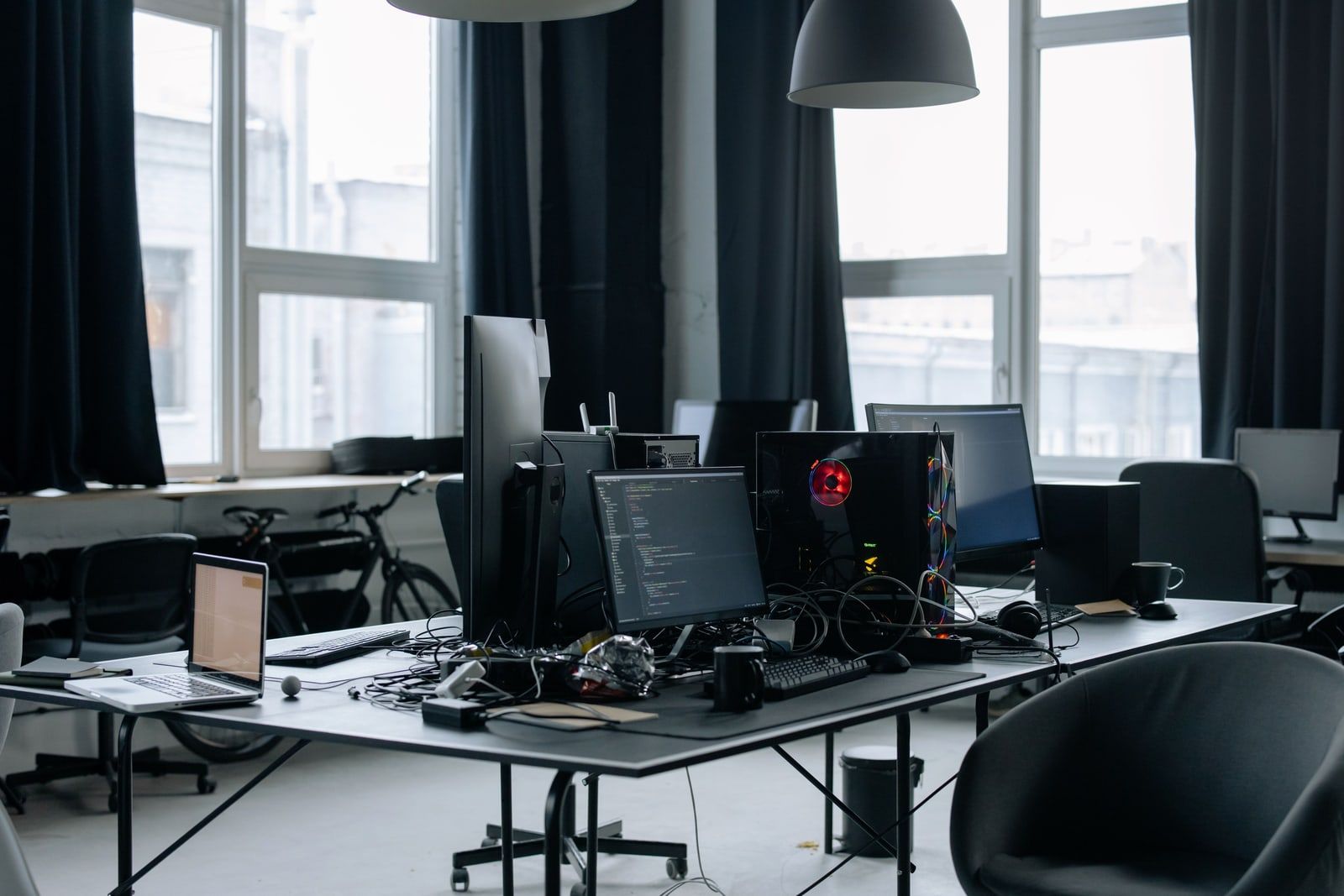 A row of office workstations with computer monitors
