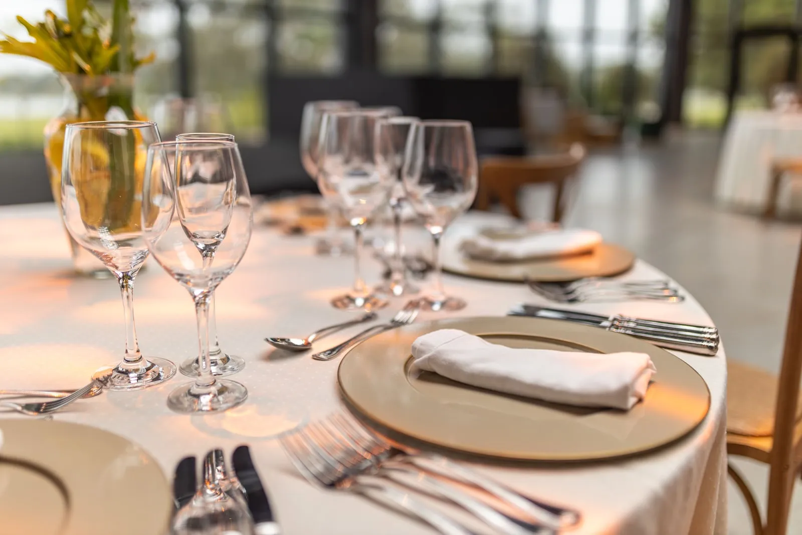 A formal dining table set with plates and glasses