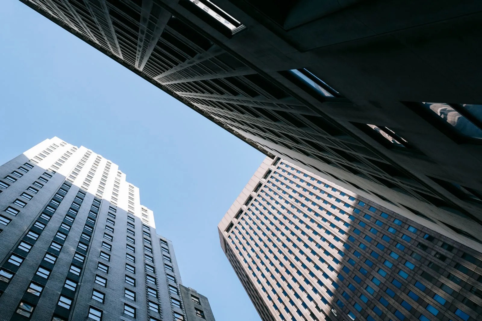 Office towers seen from below against a blue sky