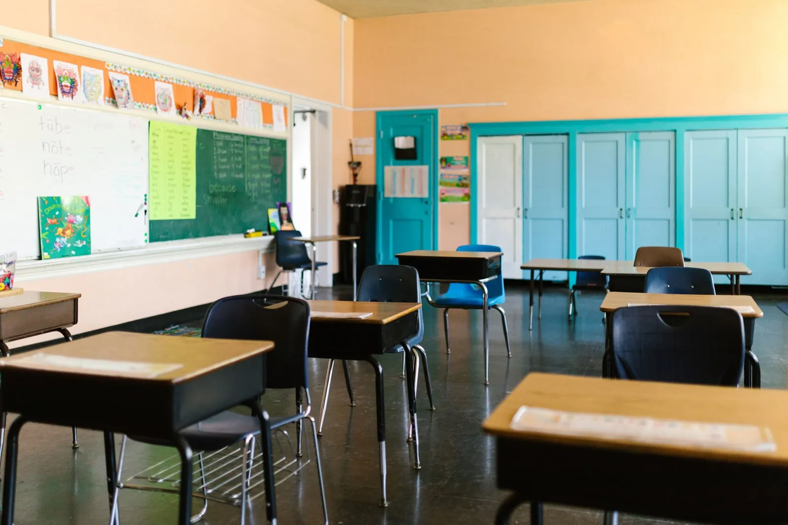 An empty school classroom with rows of desks