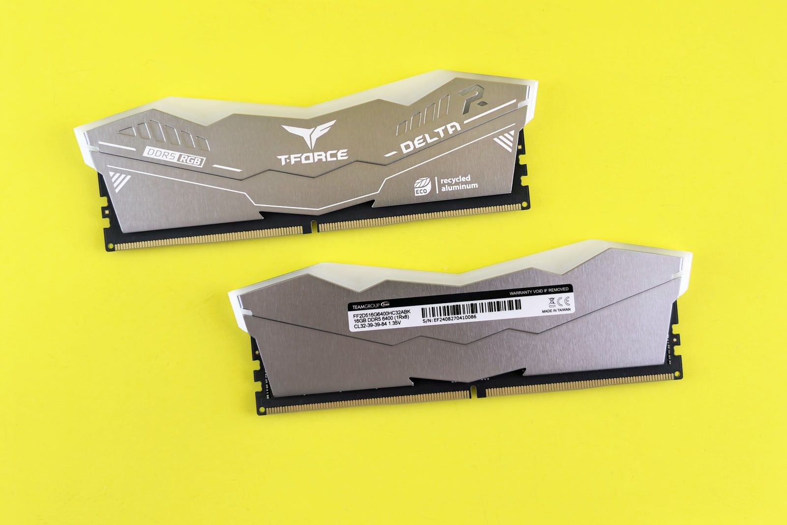 Two DDR5 memory modules on a bright yellow background