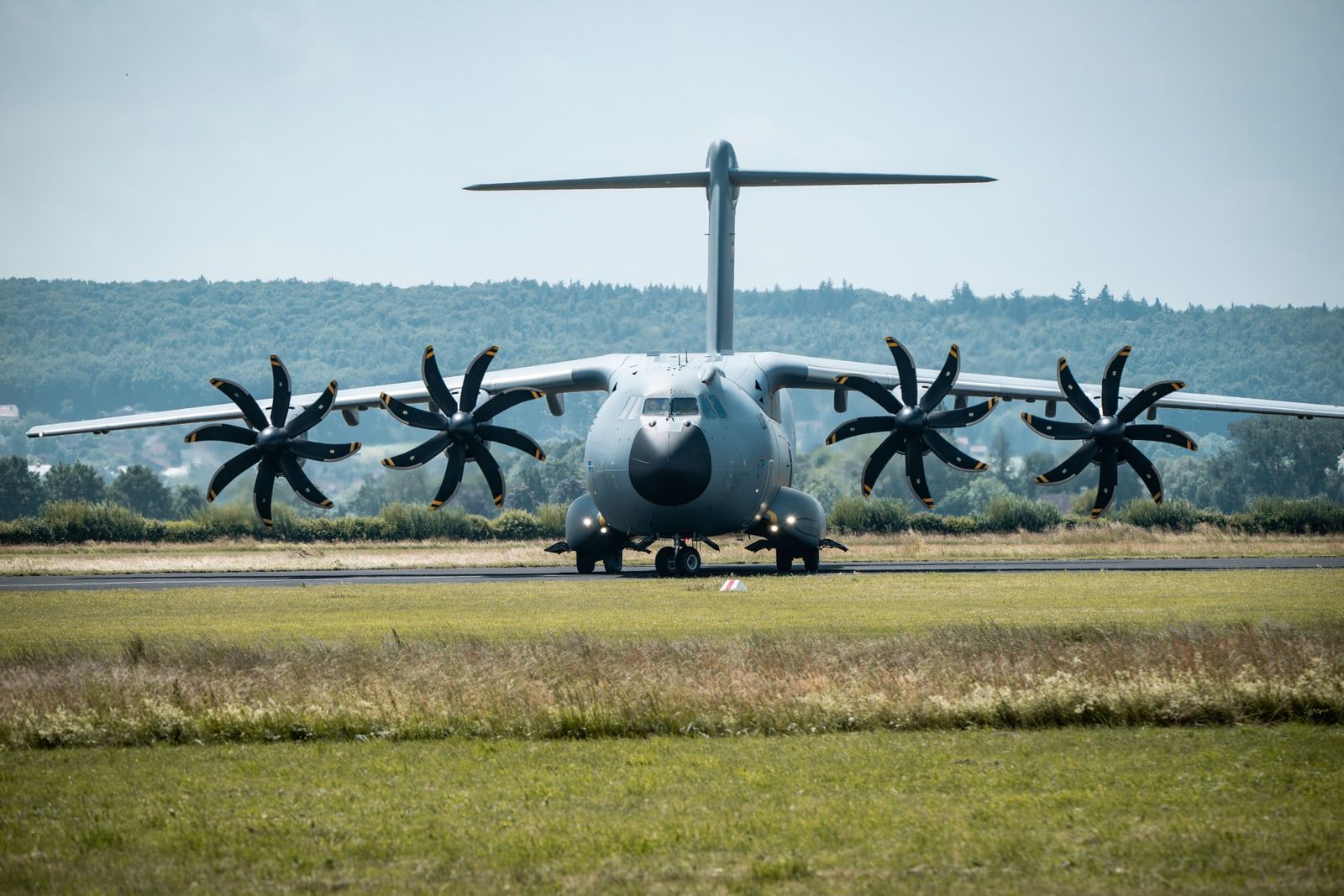 A military transport aircraft parked on an airfield