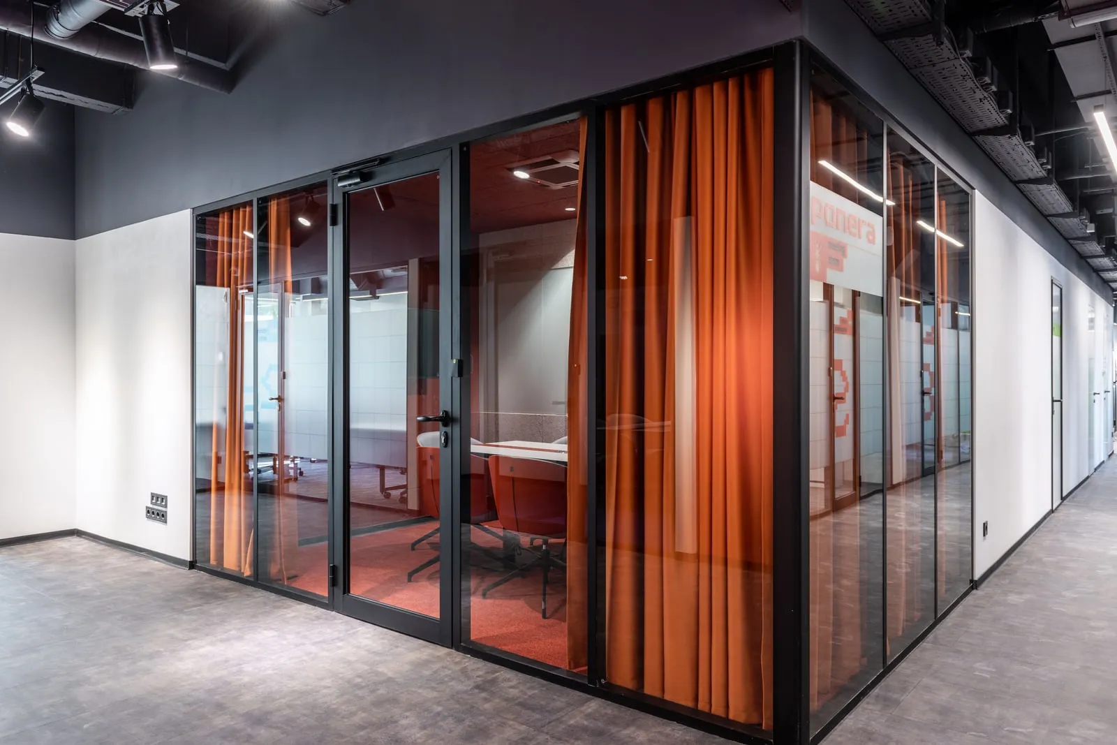 A corridor with glass walls in an office building