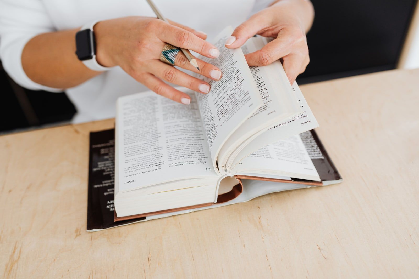 An open dictionary on a wooden table