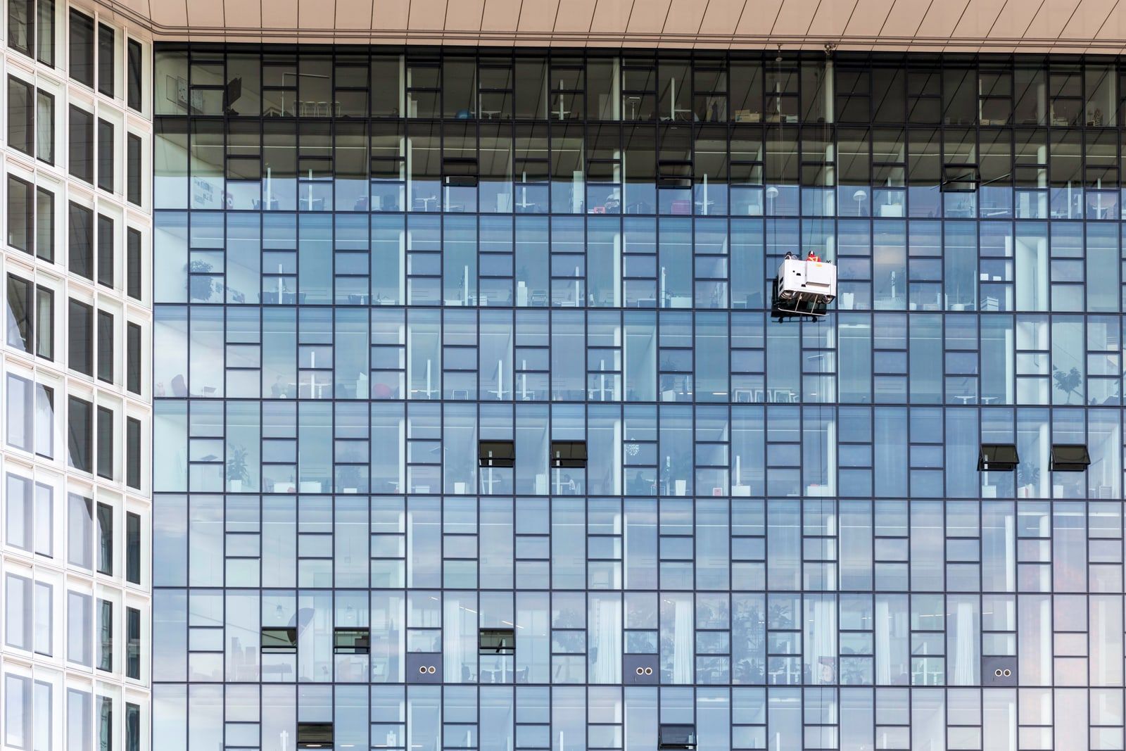 The glass facade of a modern office building