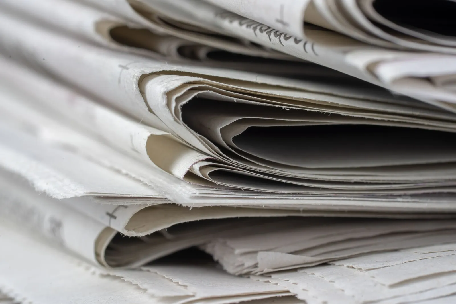 Large rolls of newsprint paper in a printing plant