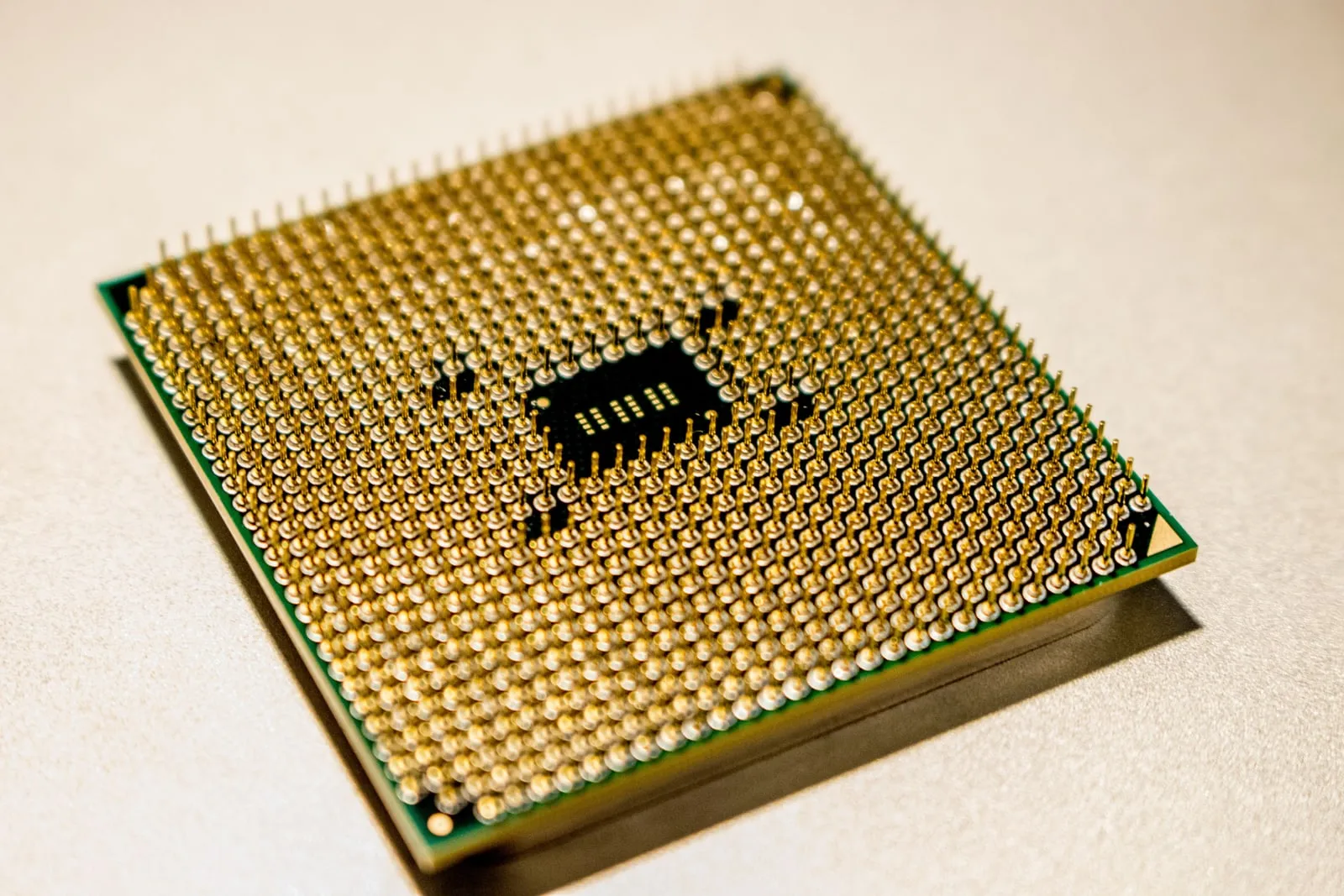 The underside of a processor, showing its grid of gold pins