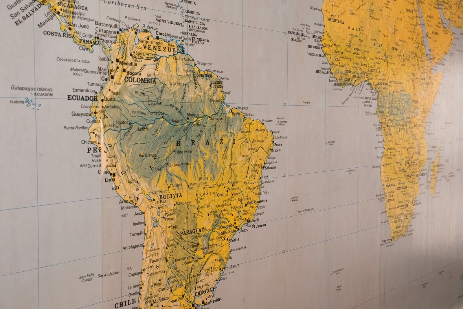 A printed wall map showing South America and Africa