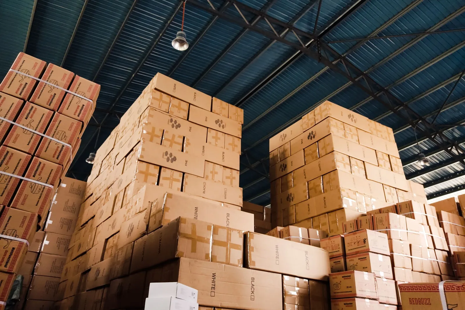 Cardboard boxes stacked high in a warehouse
