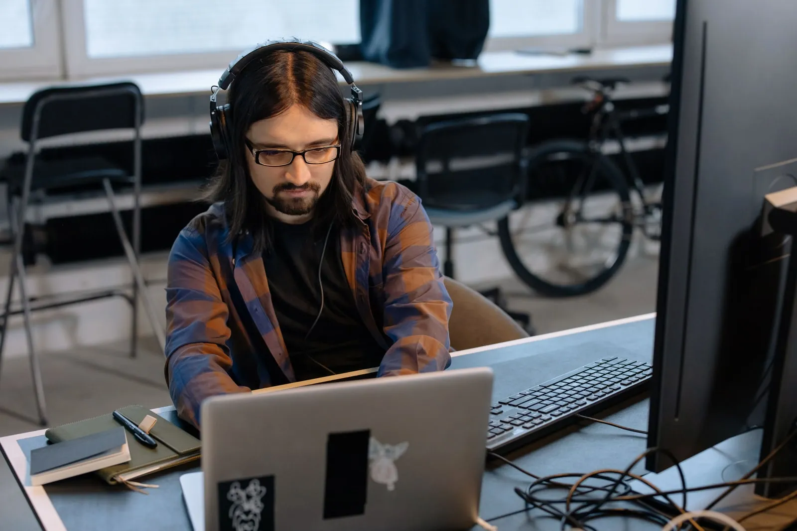 A developer working at a laptop in an office