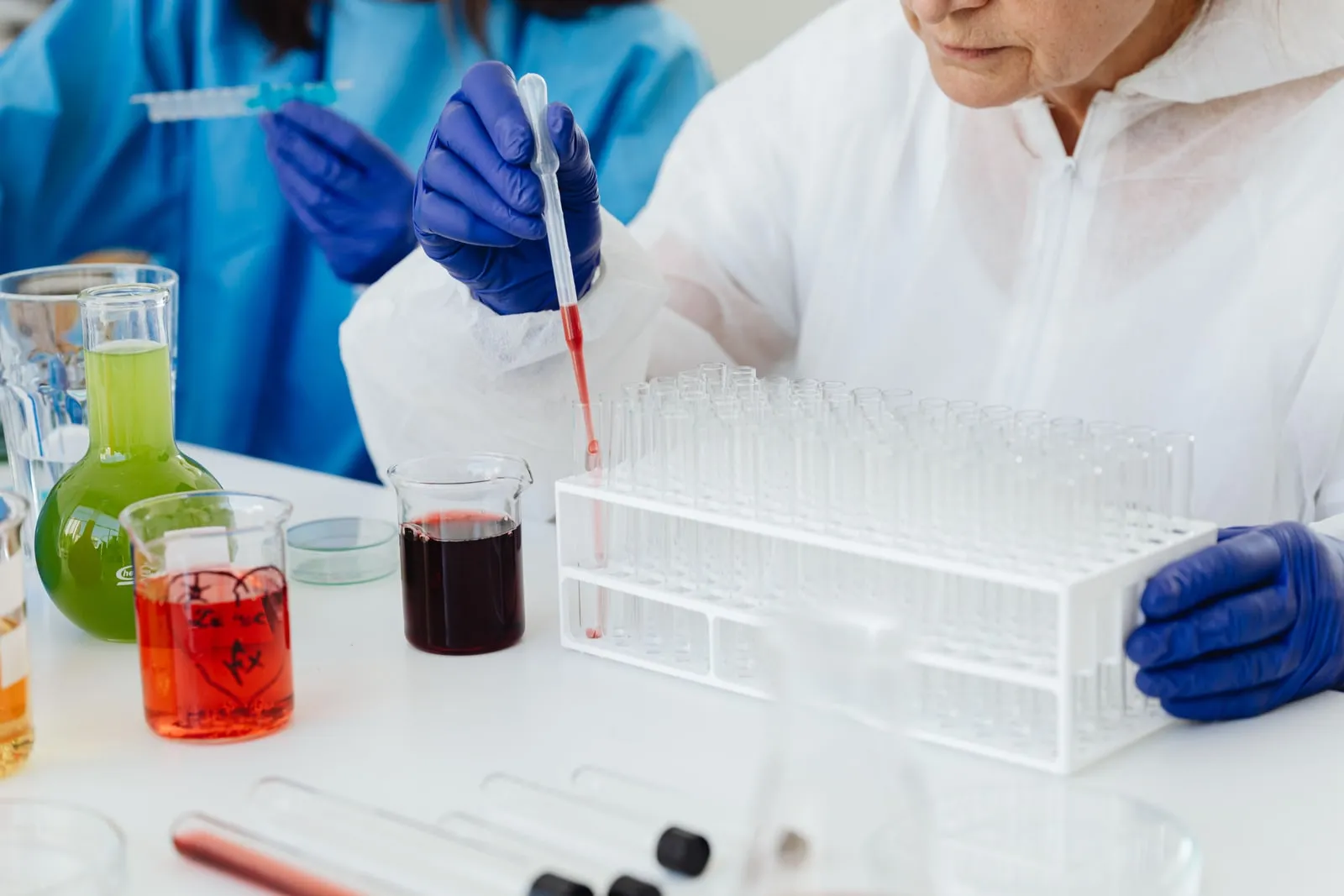 A scientist working in a laboratory with pipettes