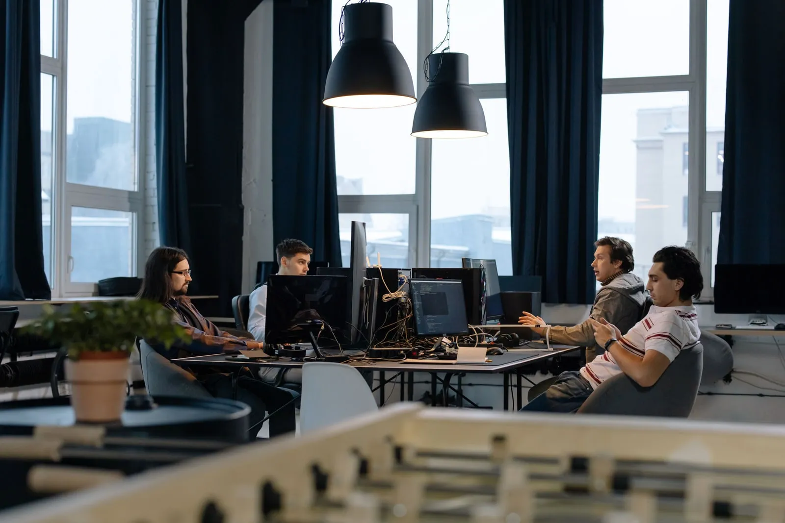 Programmers working at desks in an open plan office
