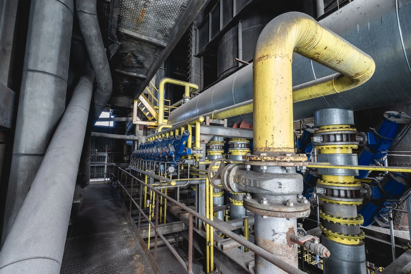 Cooling pipes and valves in an industrial plant room