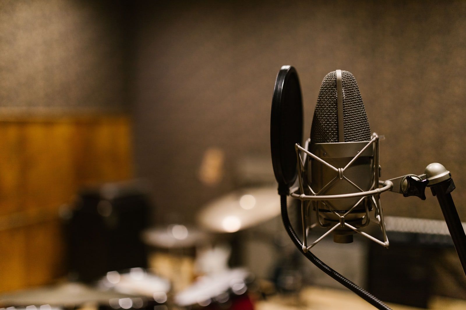 A microphone on a stand in a recording studio
