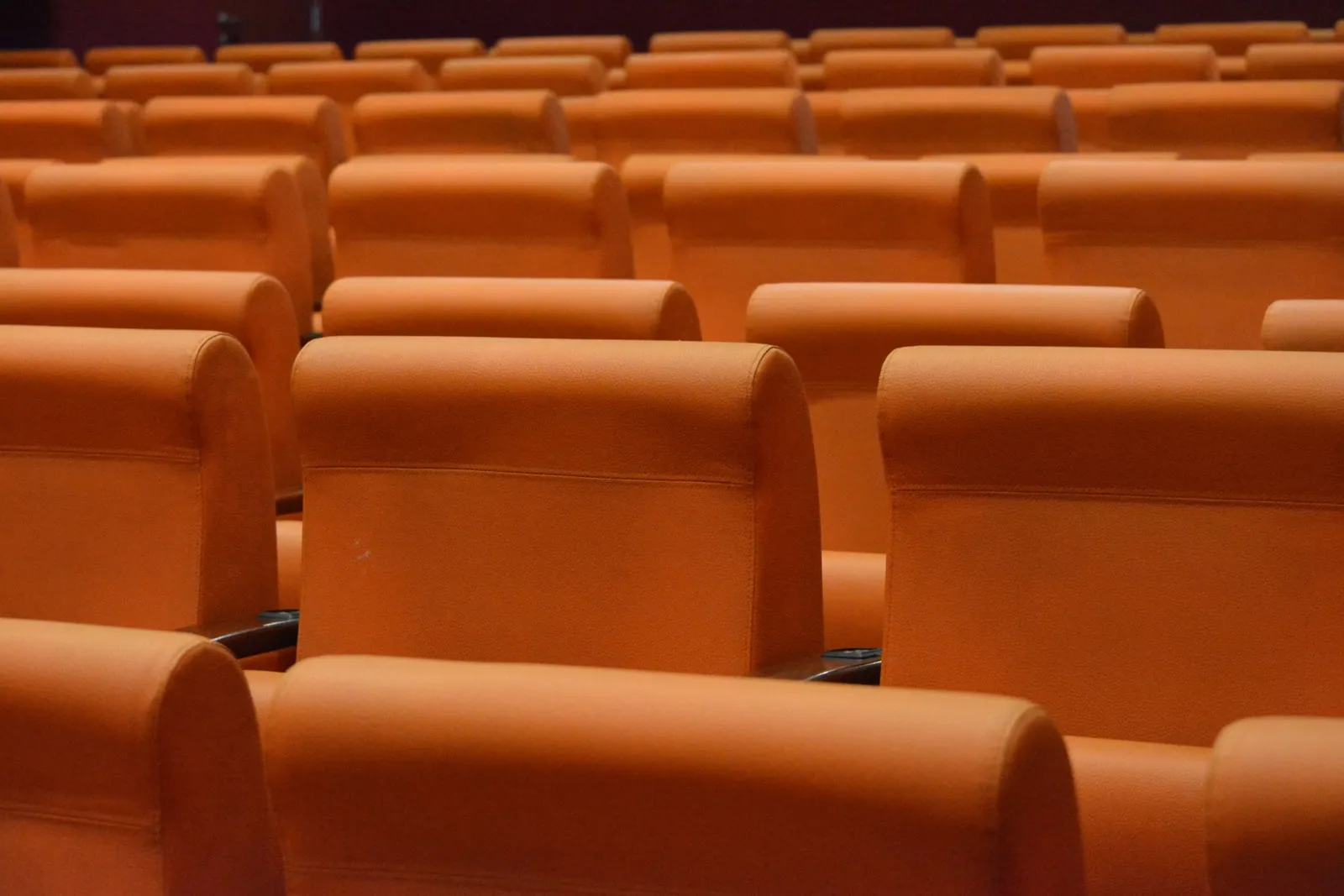 Rows of empty auditorium seats before an event