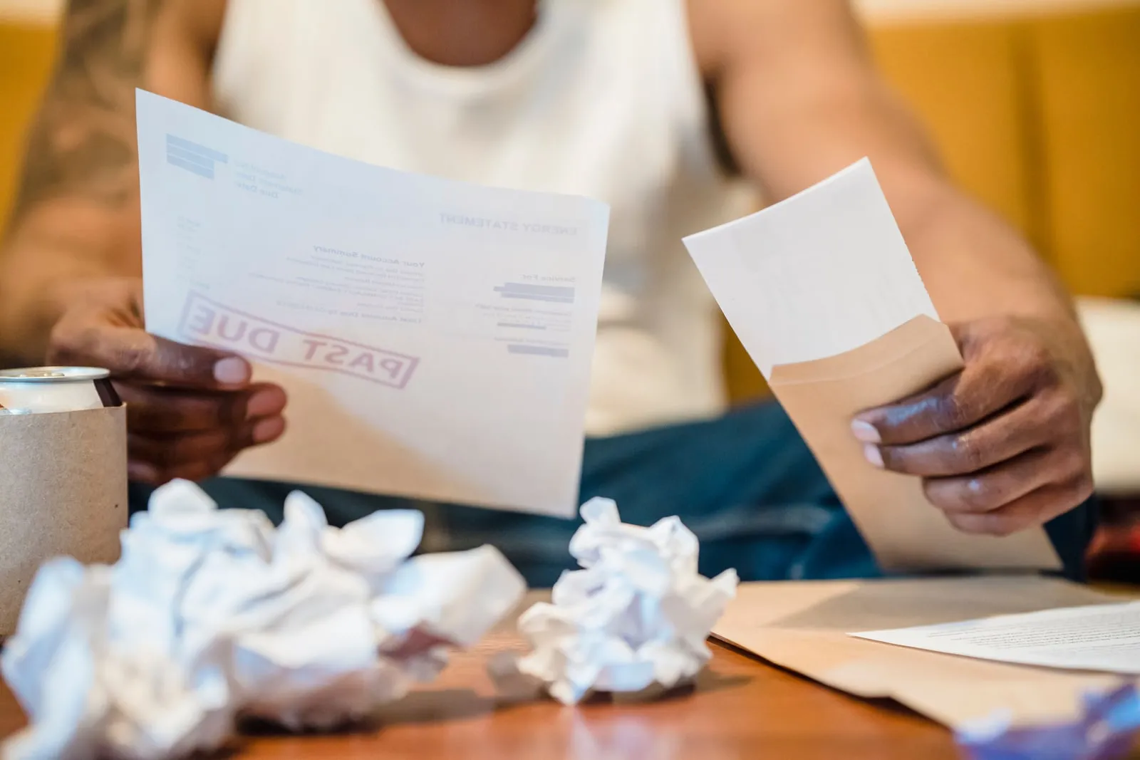 Paper bills and envelopes spread out on a table