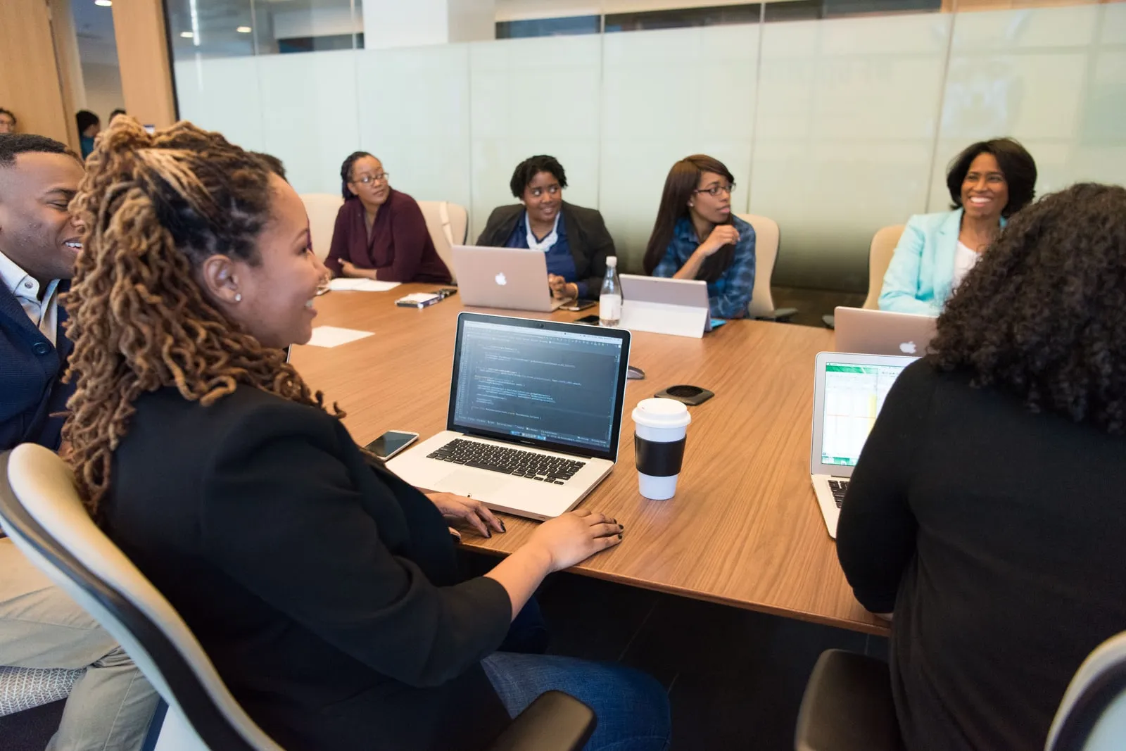 Business meeting around a conference table with laptops