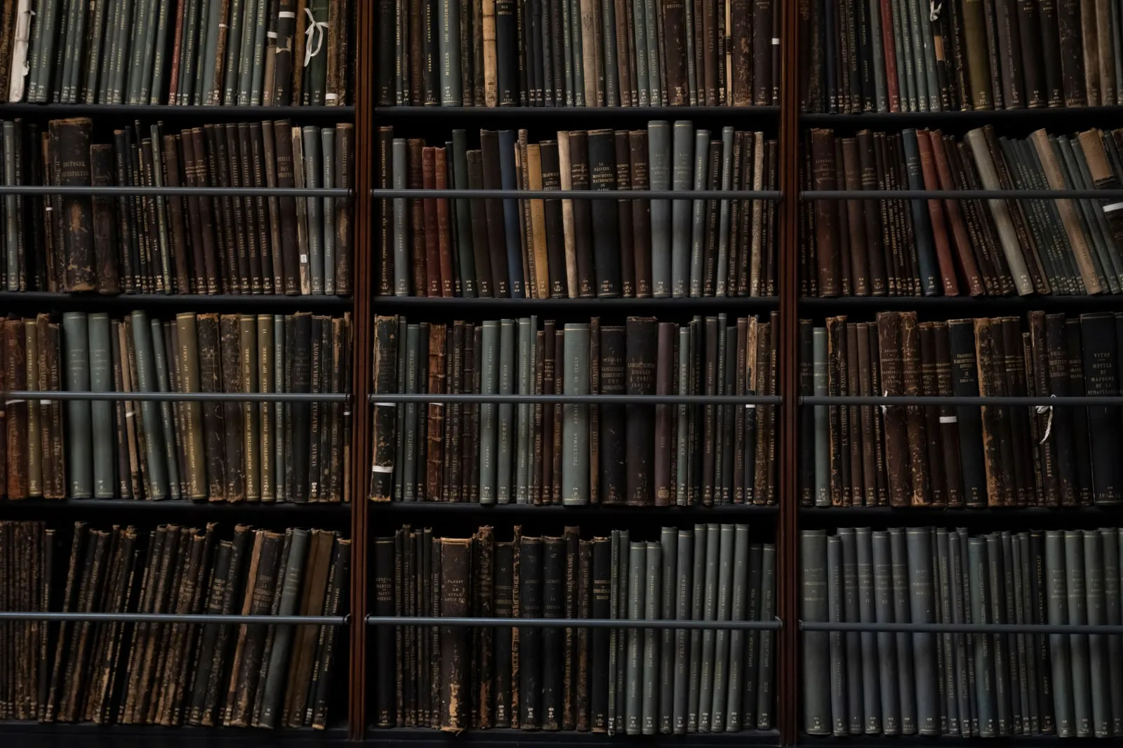 Rows of old bound volumes on library shelves