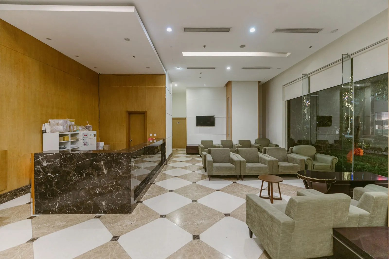 An empty waiting room with rows of chairs and a service counter