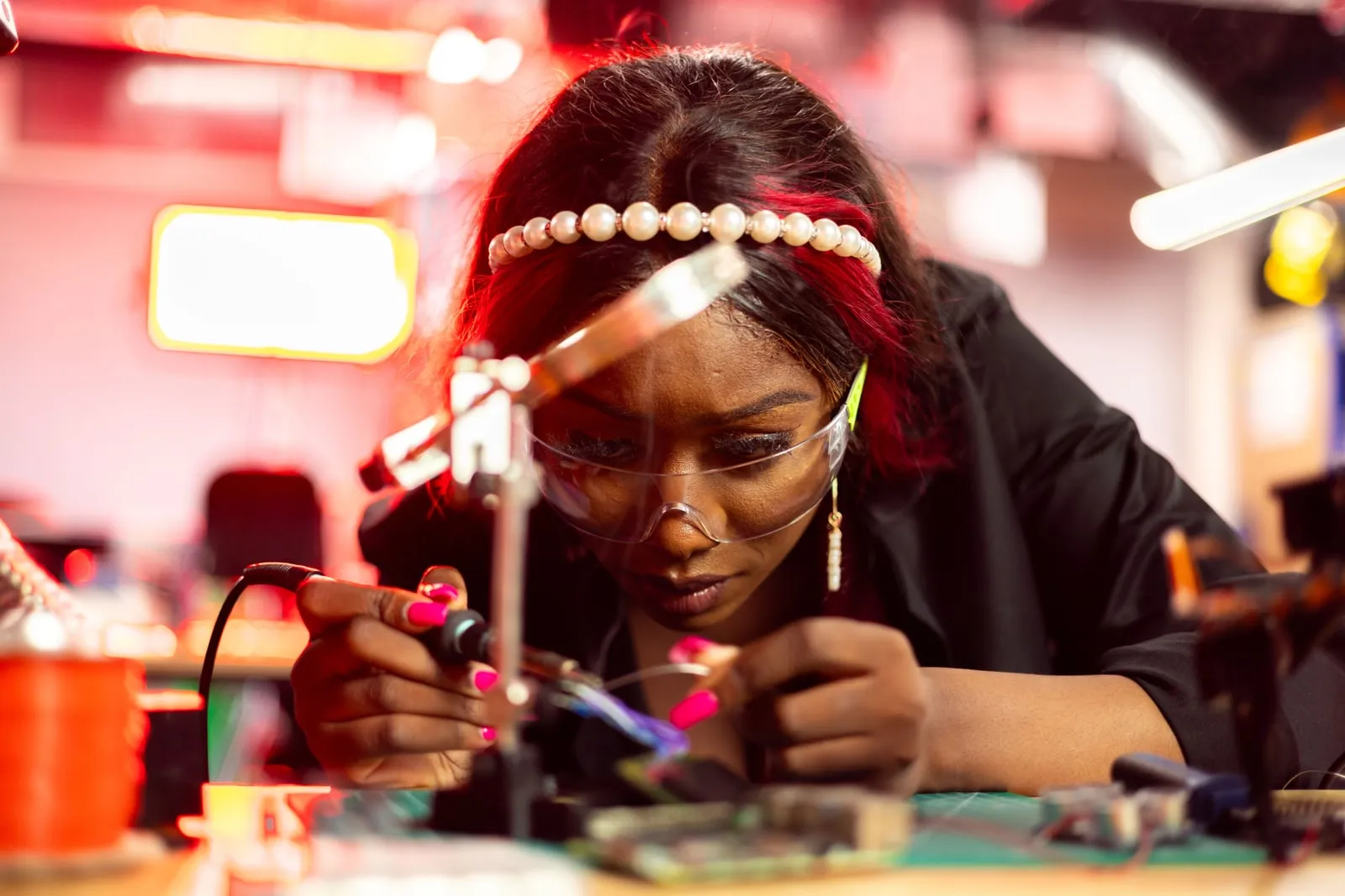 An engineer working on electronic components at a workbench