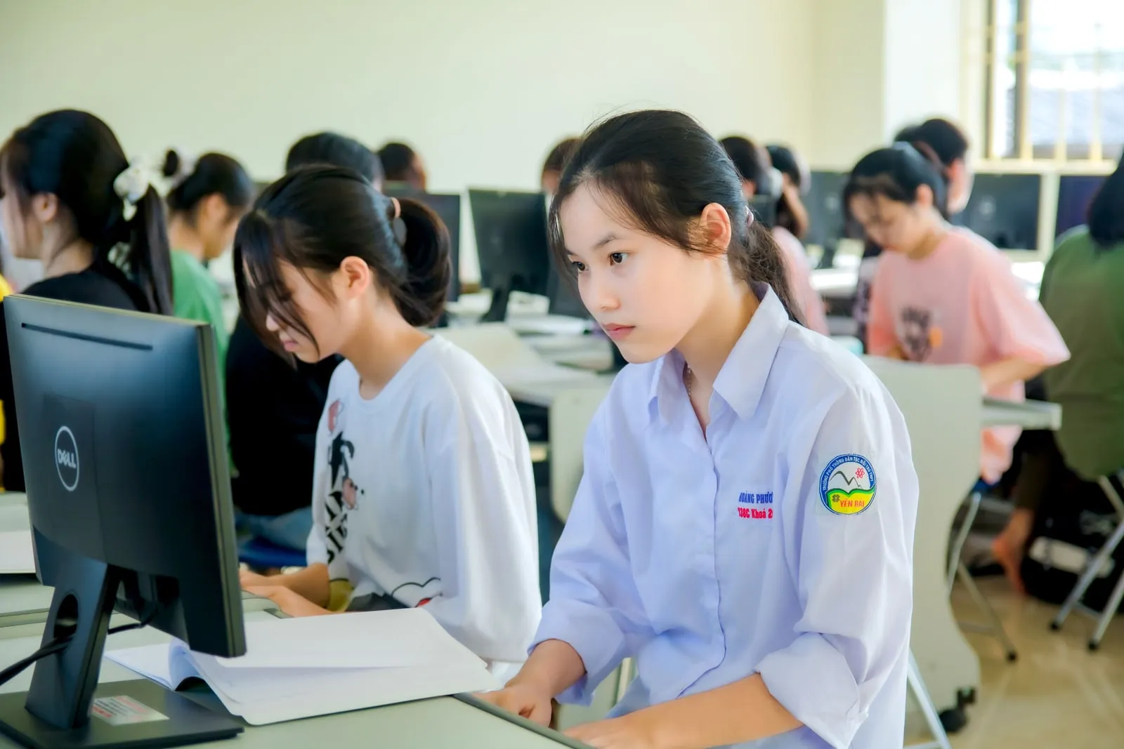 Students working at computers in a classroom