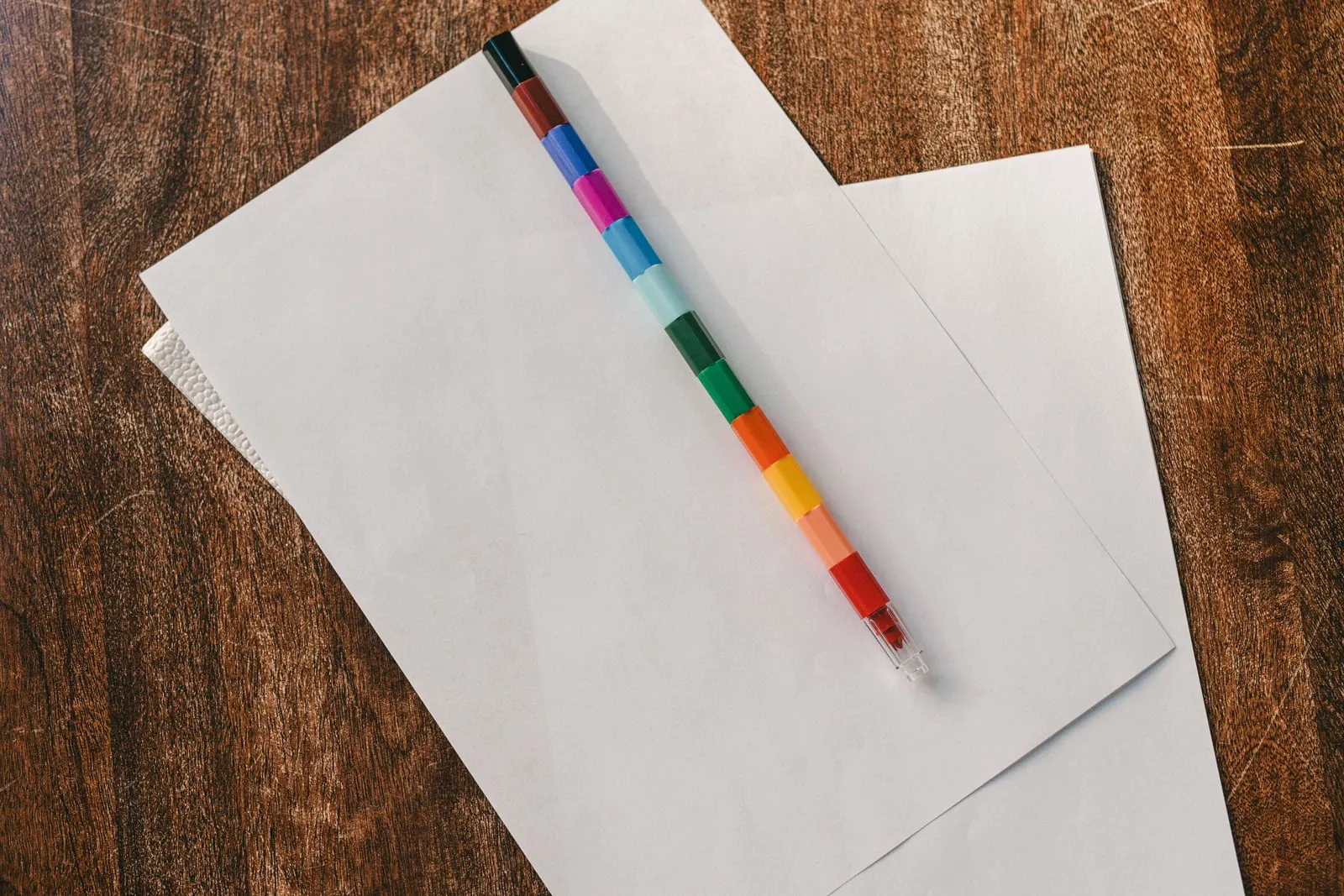 A pencil lying on a blank paper worksheet