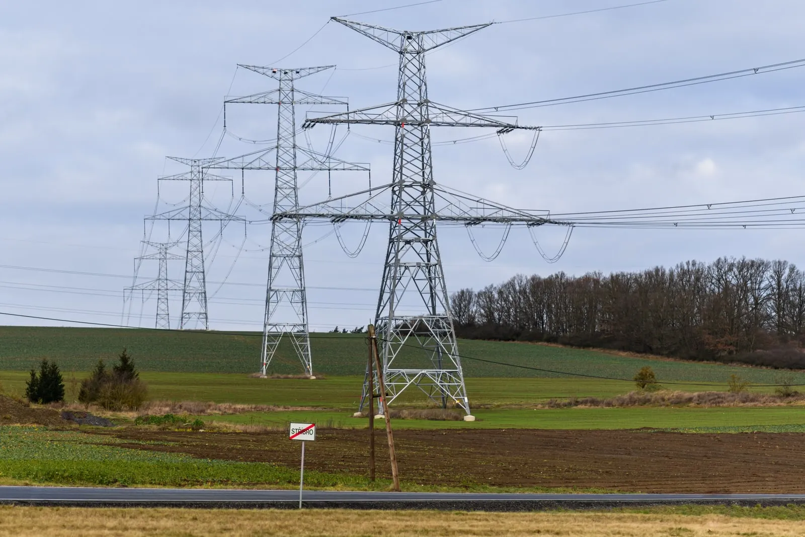 High-voltage transmission pylons crossing farmland